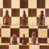 A handmade chess set featuring characters from Alice in Wonderland, placed on a checkered background.